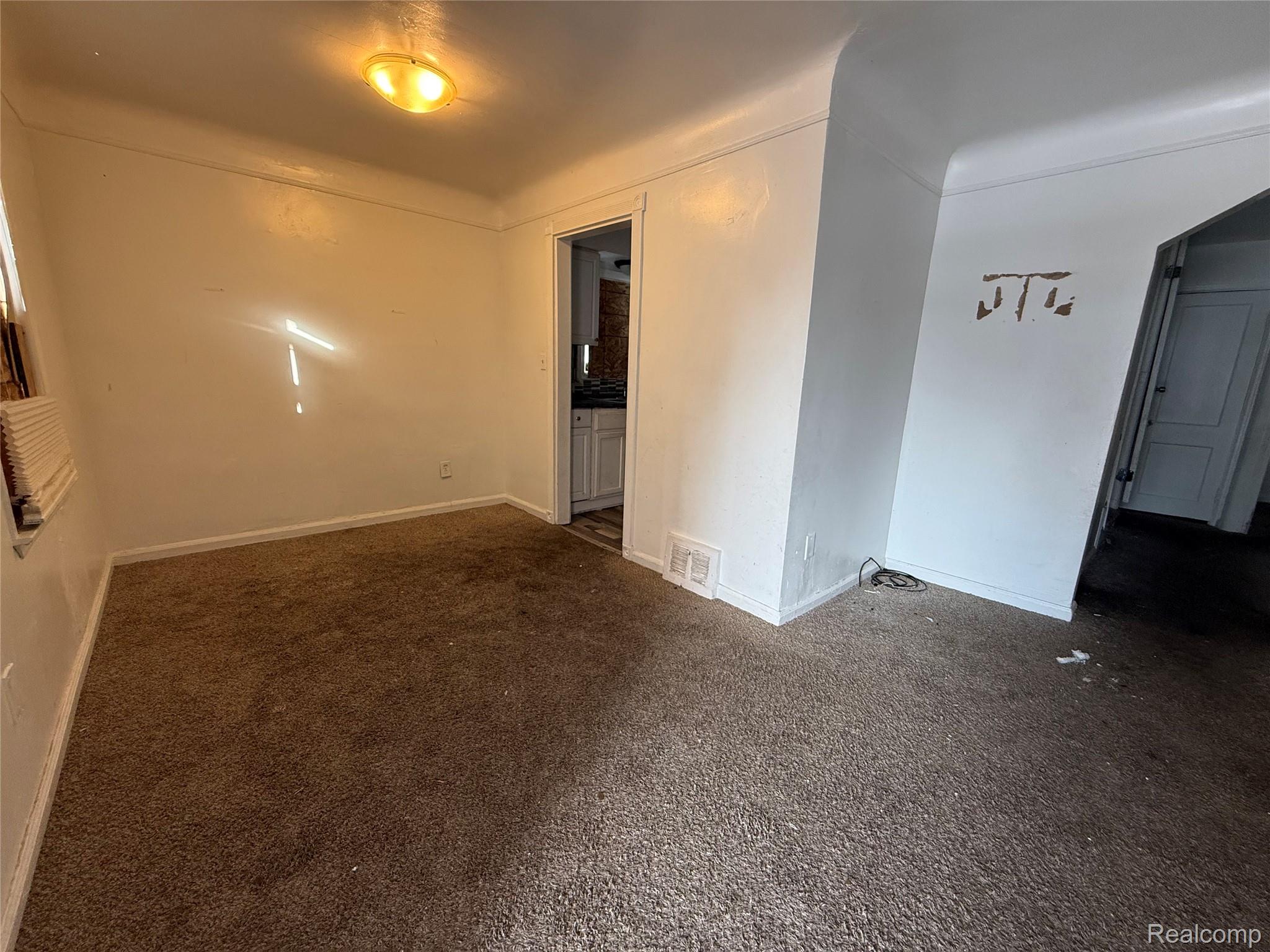 8864 Heyden Detroit, MI 48228 - Photo 5 of 16 Empty room with dark colored carpet and baseboards