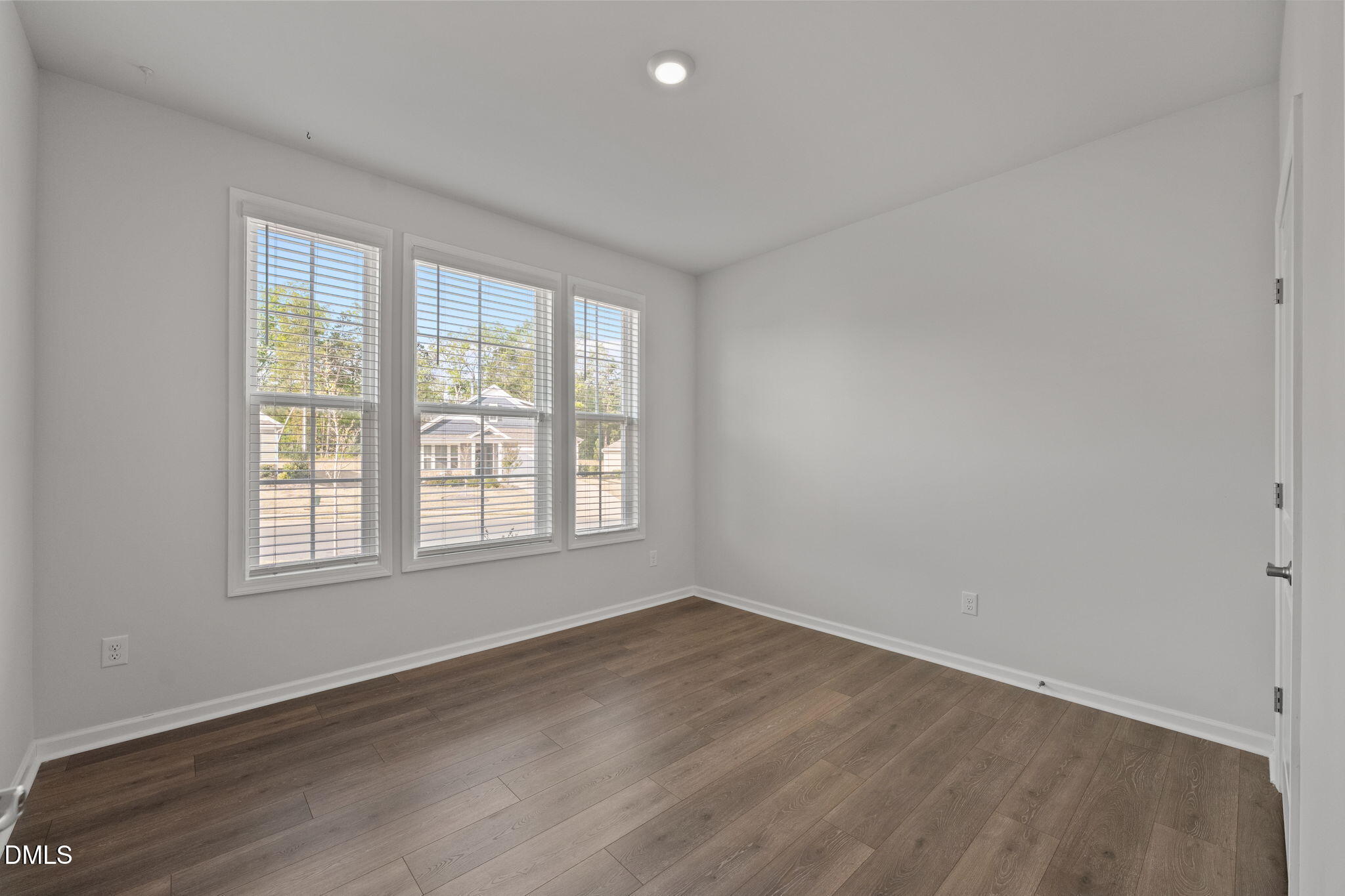 1639 Abberly Place Graham, NC 27253 - Photo 20 of 43 an empty room with wooden floor and windows