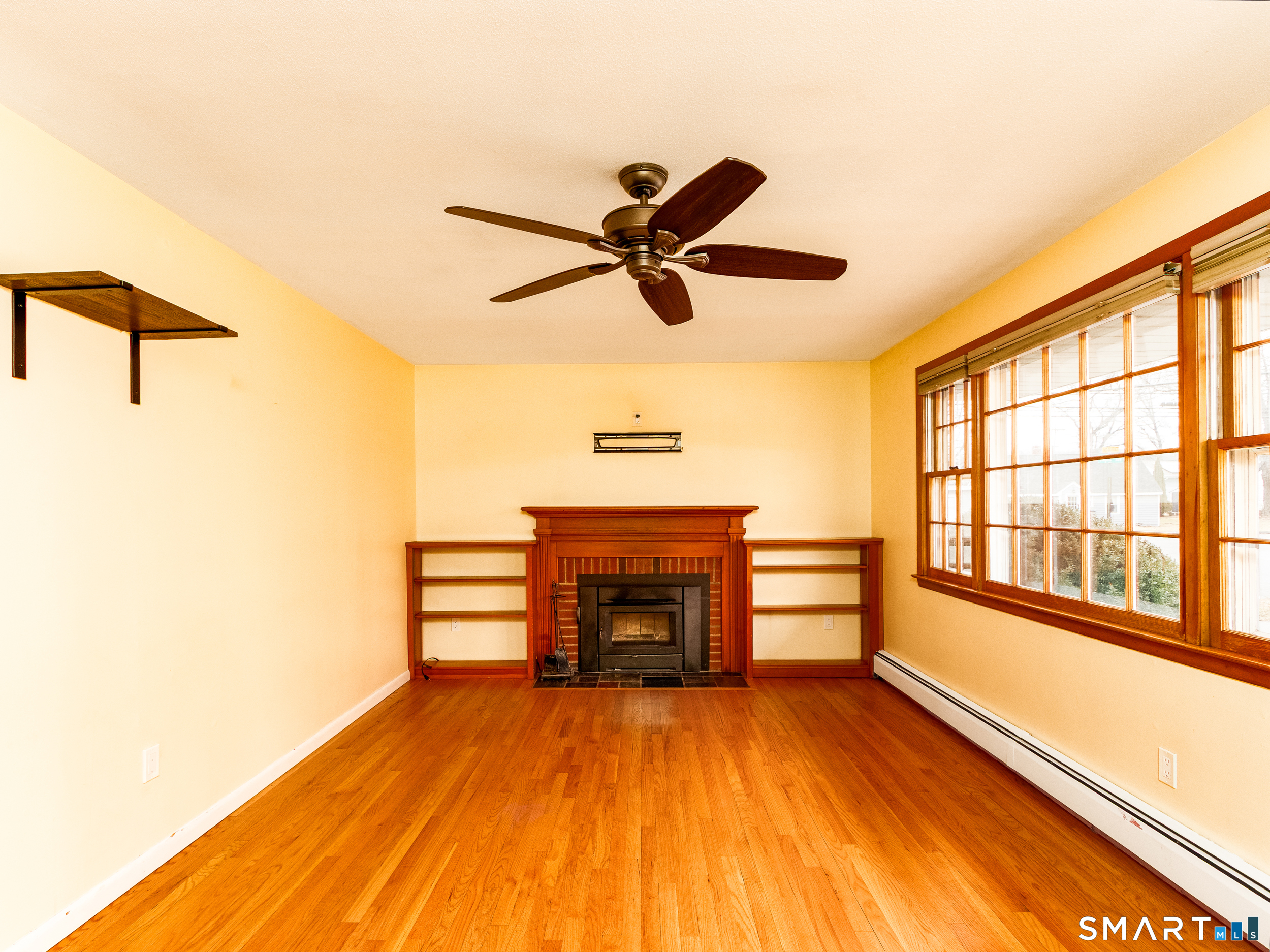 9 Empire Avenue Meriden, CT 06450 - Photo 6 of 31 a view of a livingroom with a fireplace a ceiling fan and wooden floor