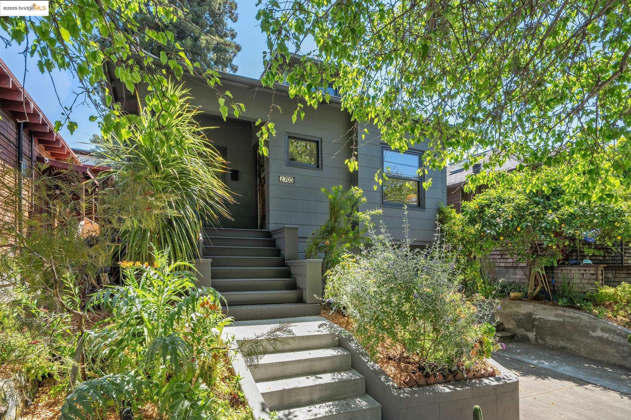 a front view of a house with plants