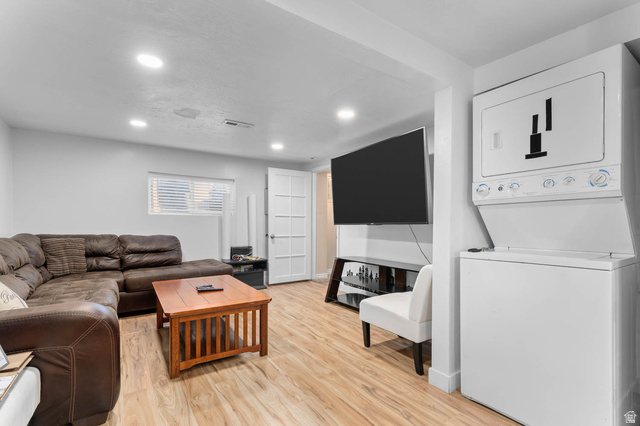 1489 North 400 West Bountiful, UT 84010 - Photo 25 of 47 Recessed lighting illuminates this room featuring wood-finish flooring, a white paneled door, and a window with horizontal blinds
