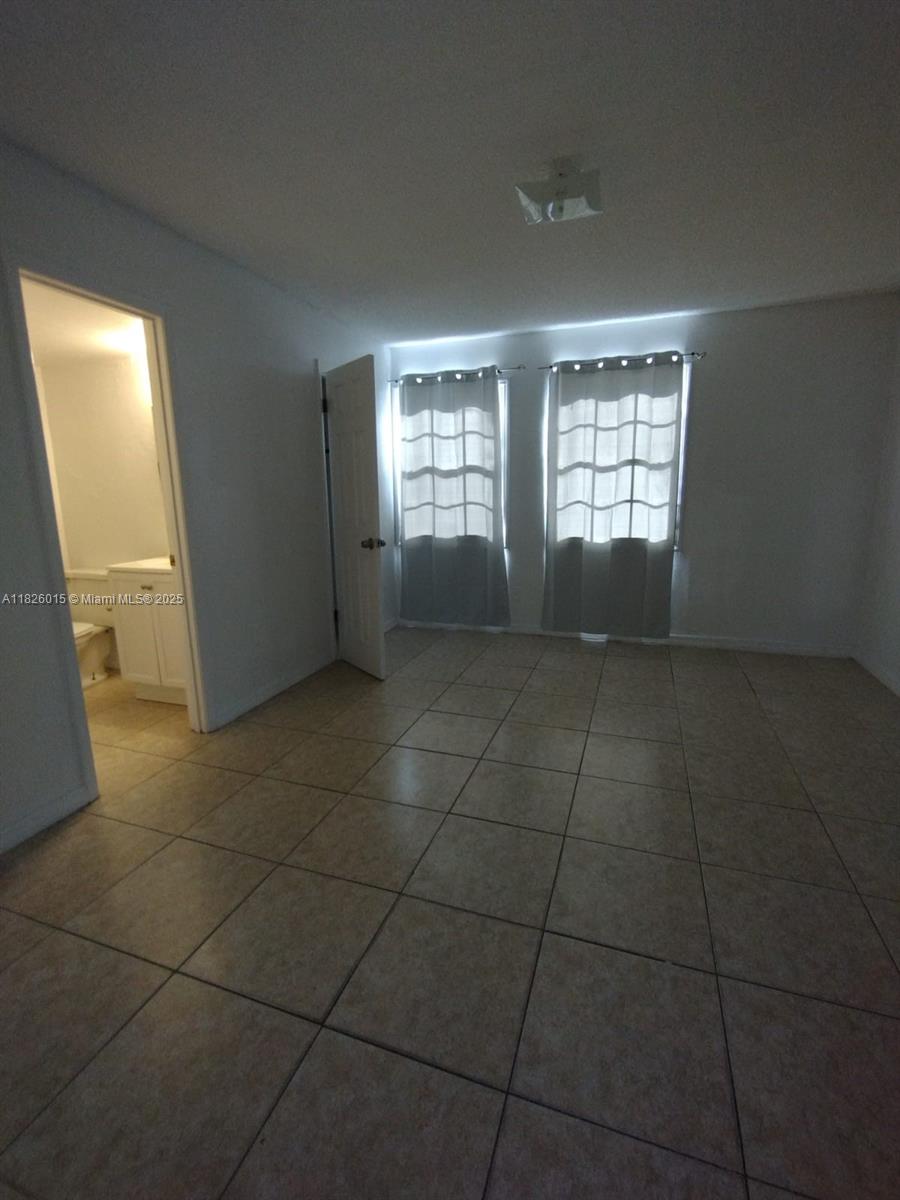 2775-l B L B McLeod Road, Unit B Orlando, FL 32805 - Photo 11 of 13 a view of an empty room with a window