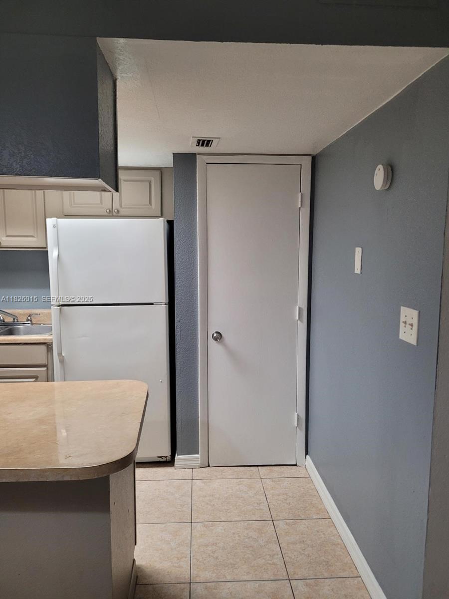 2775-l B L B McLeod Road, Unit B Orlando, FL 32805 - Photo 12 of 28 a kitchen with a refrigerator and a refrigerator