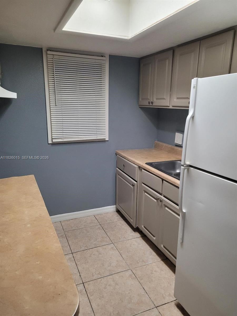 2775-l B L B McLeod Road, Unit B Orlando, FL 32805 - Photo 19 of 28 a kitchen with stainless steel appliances granite countertop a refrigerator sink and cabinets