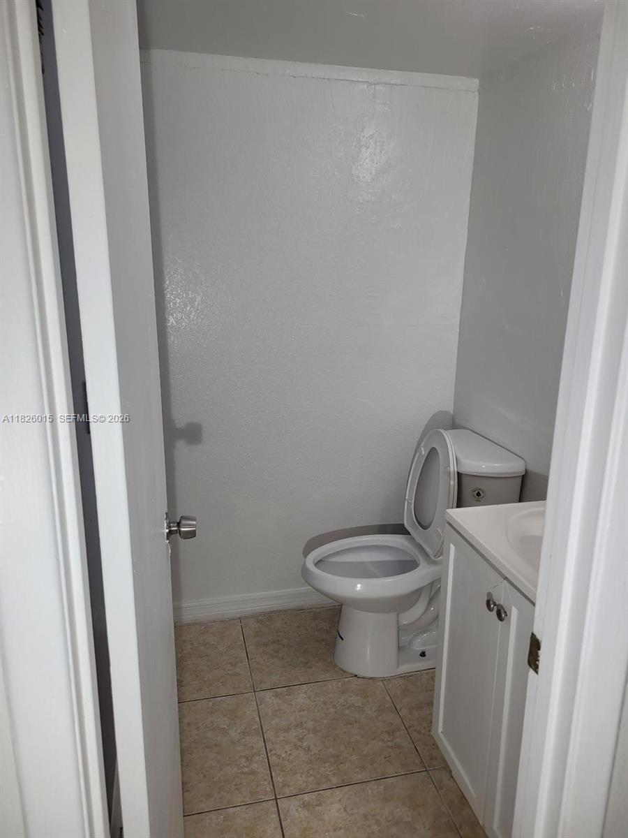 2775-l B L B McLeod Road, Unit B Orlando, FL 32805 - Photo 26 of 28 a white toilet sitting next to a sink and vanity
