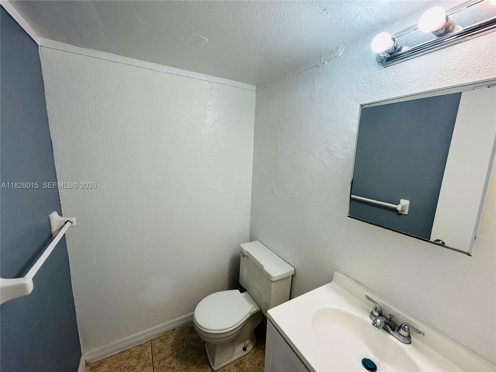 2775-l B L B McLeod Road, Unit B Orlando, FL 32805 - Photo 27 of 28 a white toilet sitting next to a bathroom sink