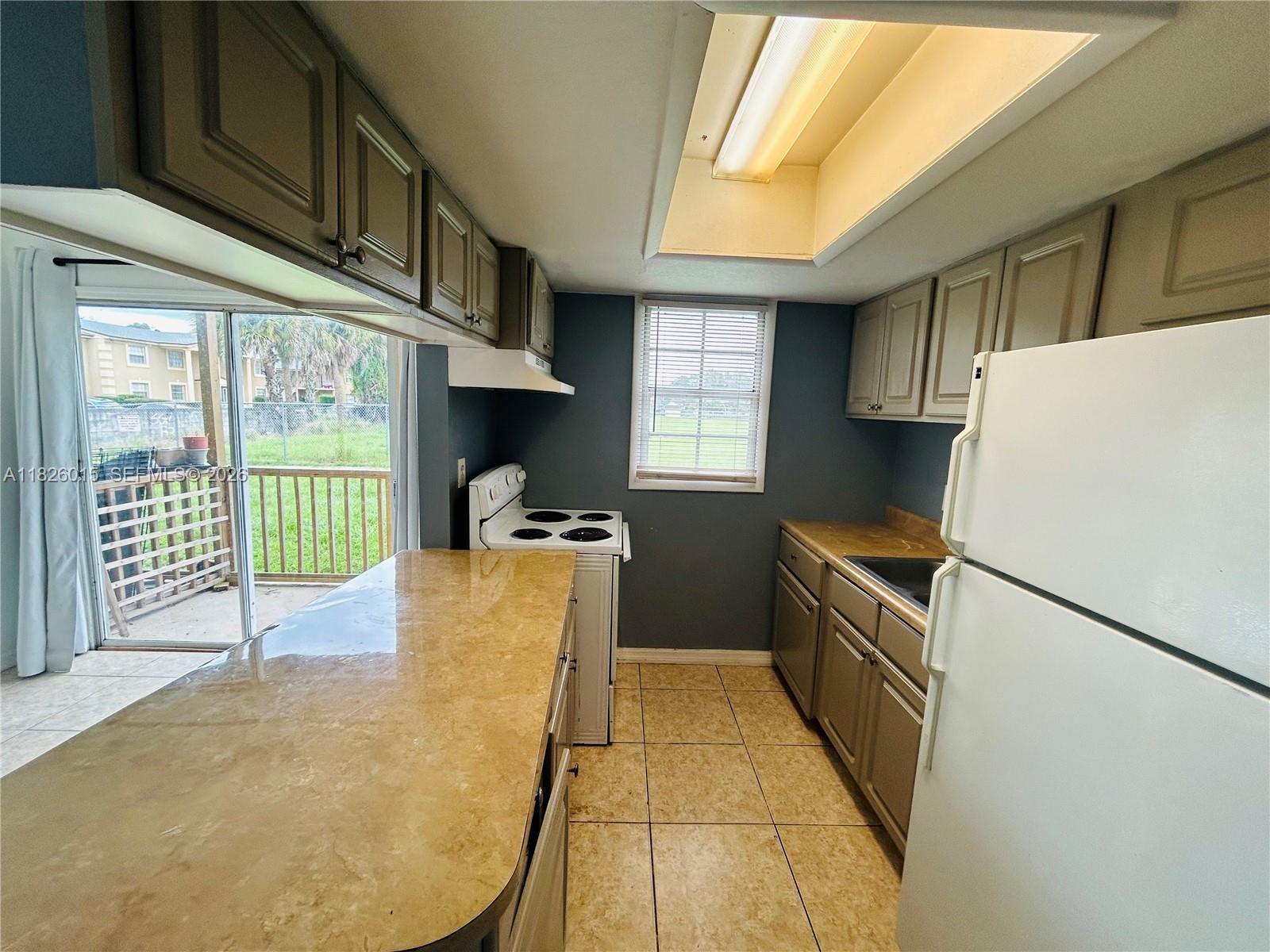 2775-l B L B McLeod Road, Unit B Orlando, FL 32805 - Photo 4 of 28 a kitchen with a large window appliances and cabinets