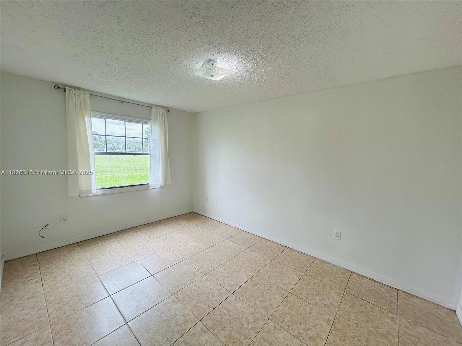 2775-l B L B McLeod Road, Unit B Orlando, FL 32805 - Photo 6 of 13 an empty room with windows