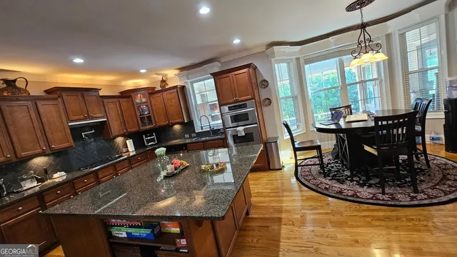 a living room with furniture flat screen tv and a large window