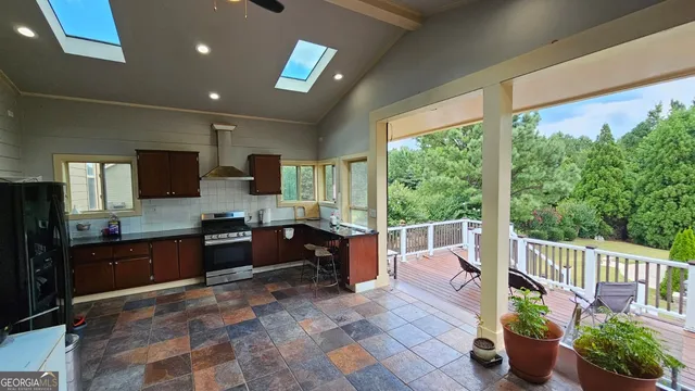 a bathroom with a granite countertop tub sink and mirror