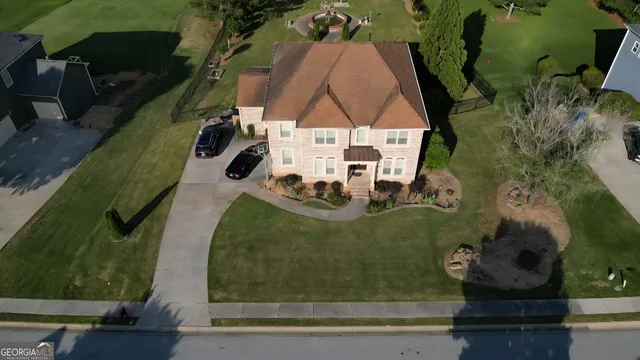 an aerial view of a residential houses with outdoor space
