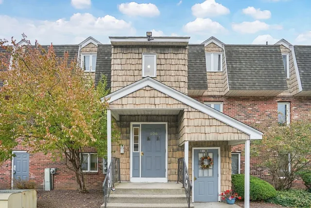 a view of a house with wooden fence and large windows