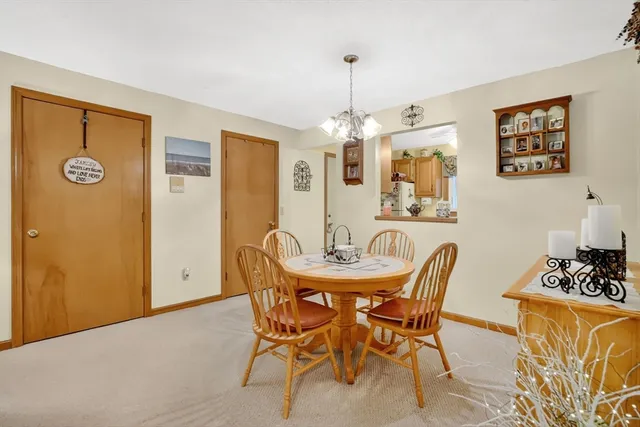 a view of a dining room with furniture and chandelier