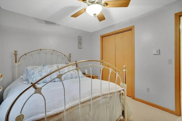 a view of staircase with a ceiling fan and a rug