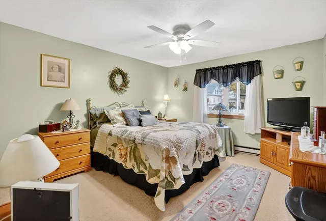 a spacious bedroom with a bed and a flat screen tv