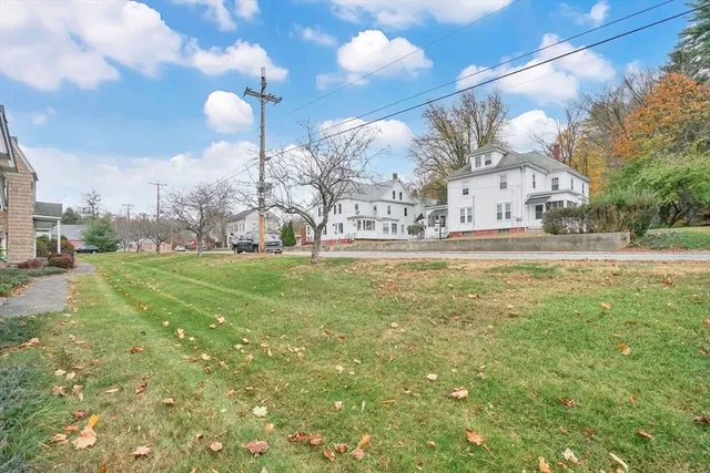 a view of a big yard of the house and front view of a house