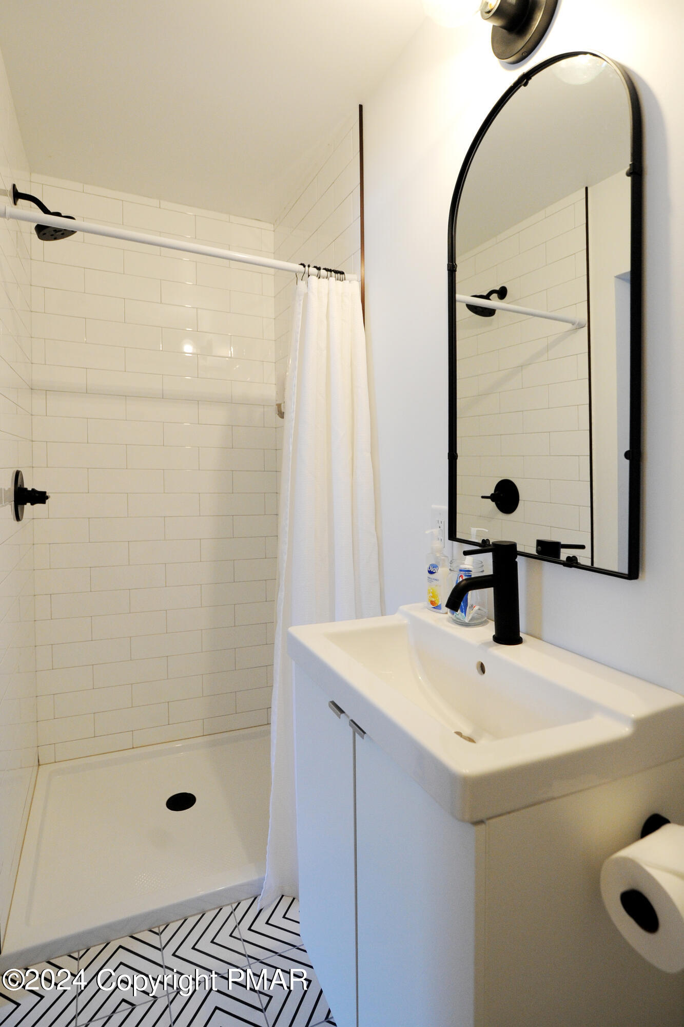 3311 Red Run Road Pocono Summit, PA 18346 - Photo 24 of 35 a bathroom with a sink a glass door shower and a mirror