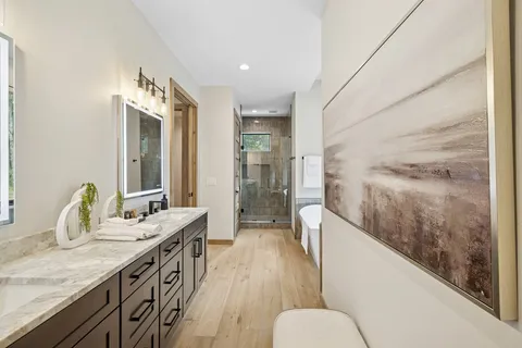 a bathroom with a double vanity sink toilet and a mirror