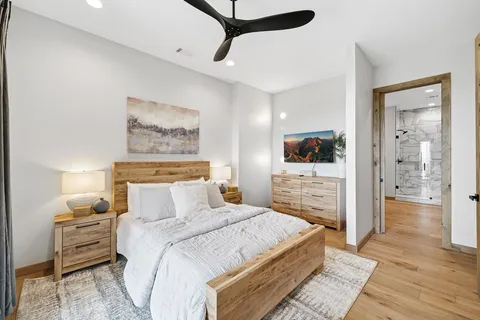 a bedroom with a large bed and a balcony view