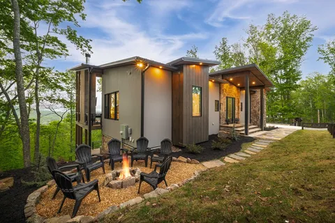 a view of house with backyard and outdoor seating