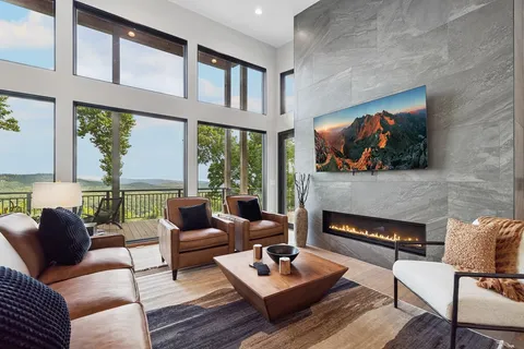 a living room with furniture tv and a large window