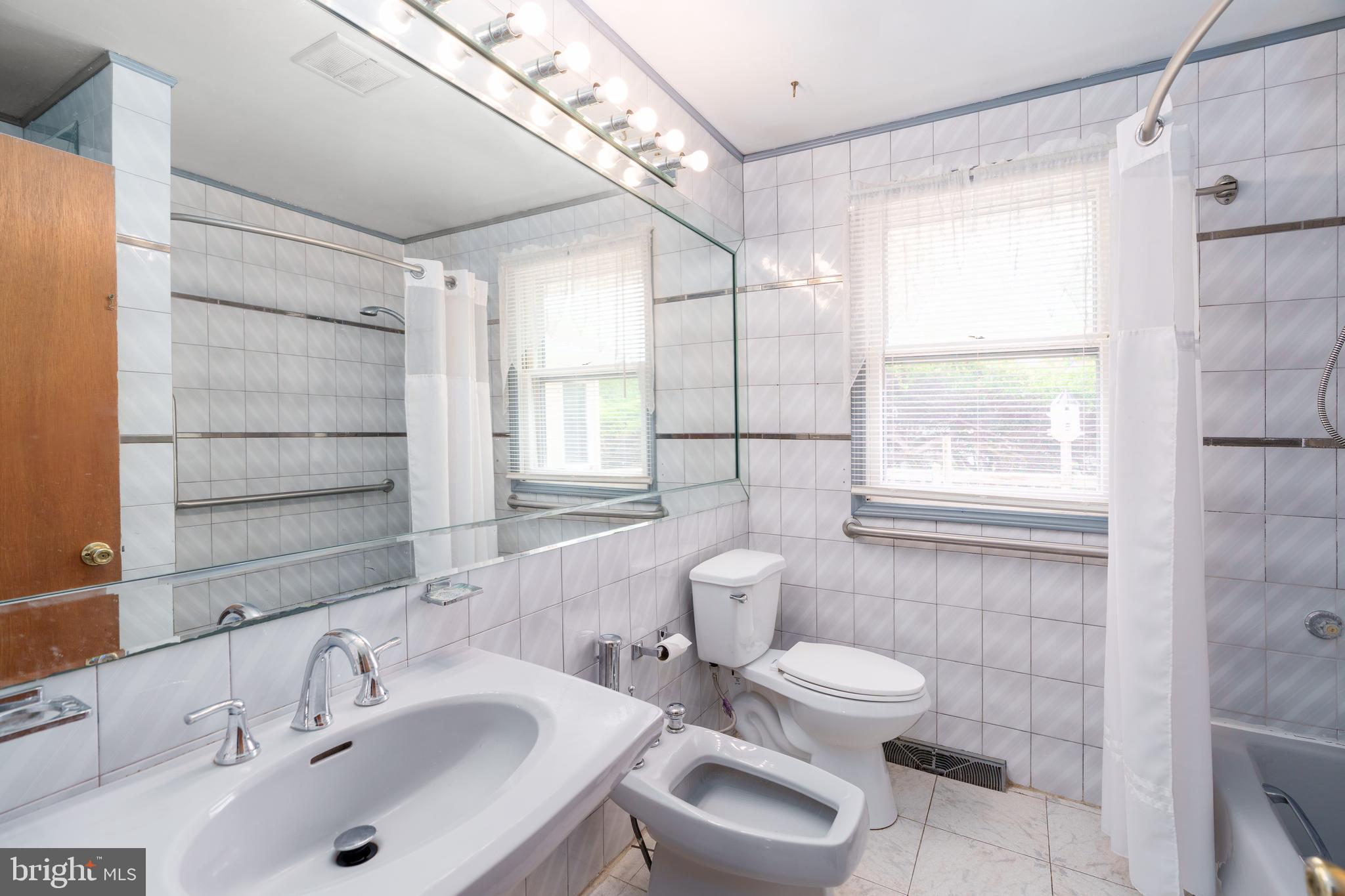 112 Park Towne Drive Elkton, MD 21921 - Photo 12 of 18 a bathroom with a sink toilet a mirror and shower