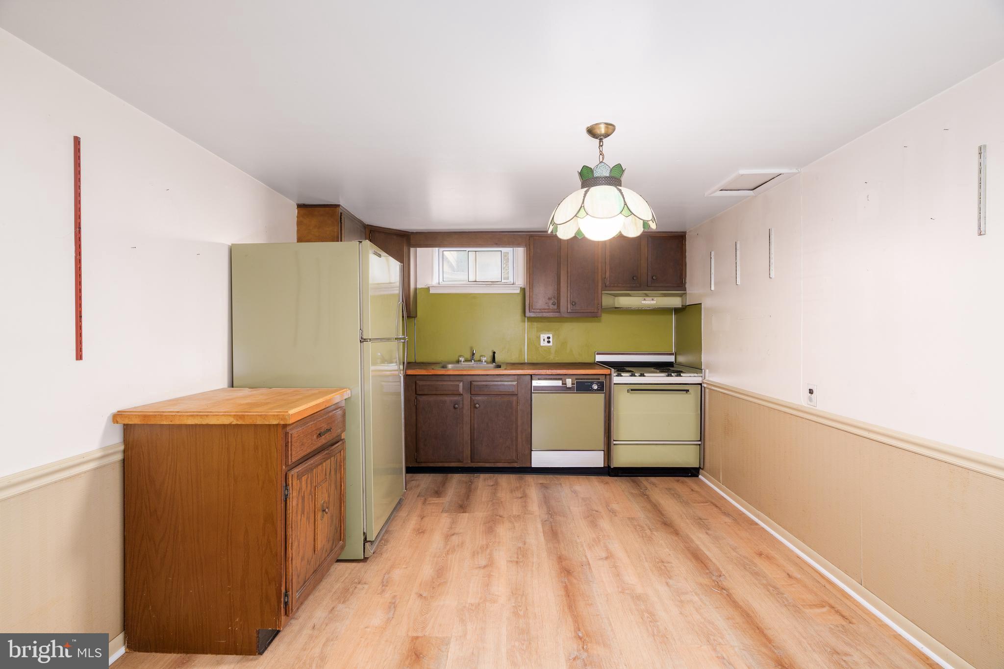 112 Park Towne Drive Elkton, MD 21921 - Photo 14 of 18 a kitchen with a refrigerator a sink dishwasher with a dining table and chairs