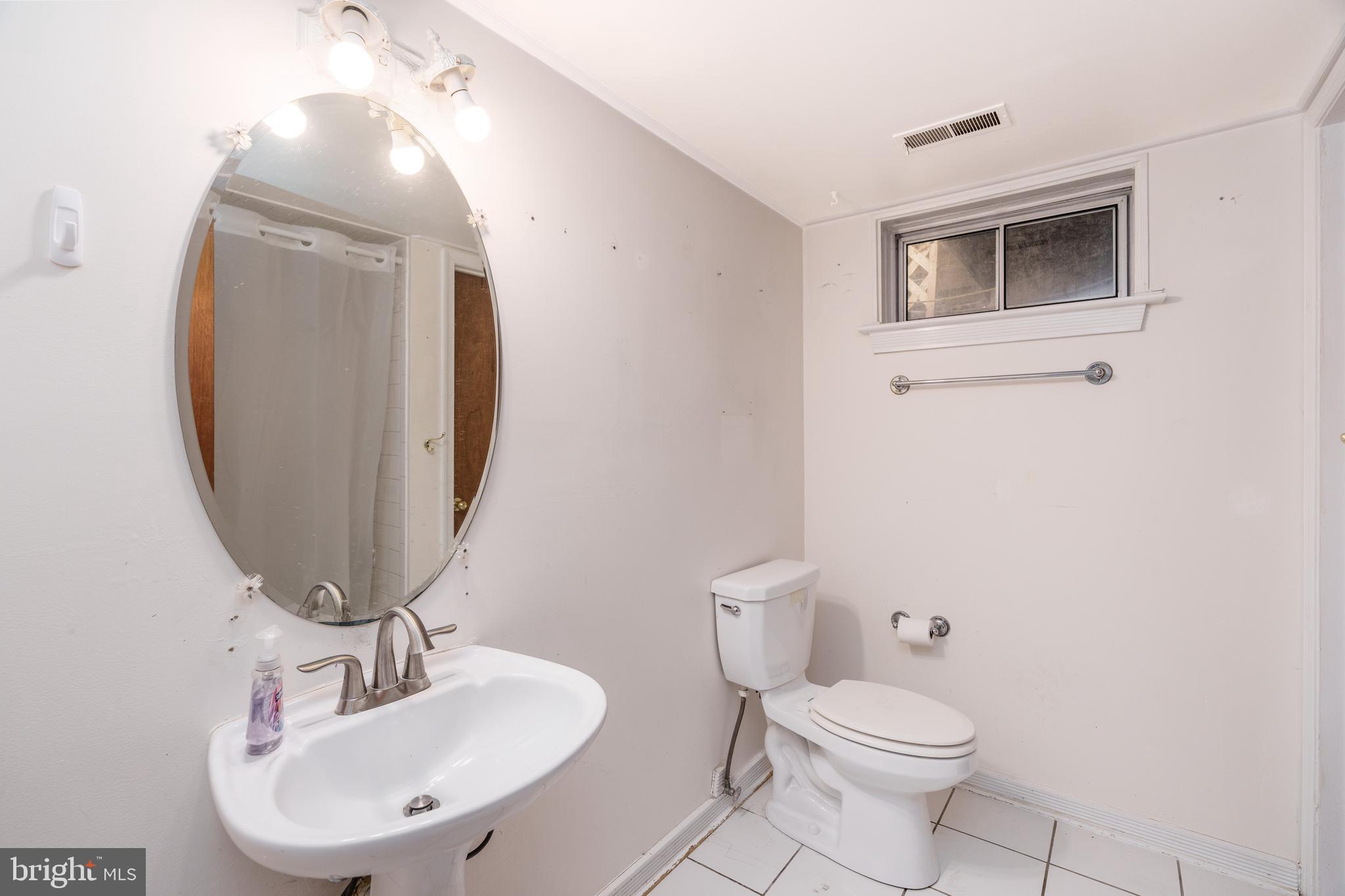 112 Park Towne Drive Elkton, MD 21921 - Photo 15 of 18 a bathroom with a toilet a sink and mirror