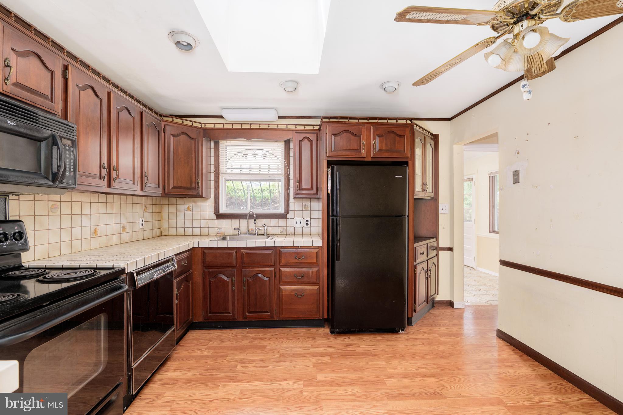 112 Park Towne Drive Elkton, MD 21921 - Photo 2 of 18 a kitchen with stainless steel appliances granite countertop a refrigerator a sink a stove a microwave and island