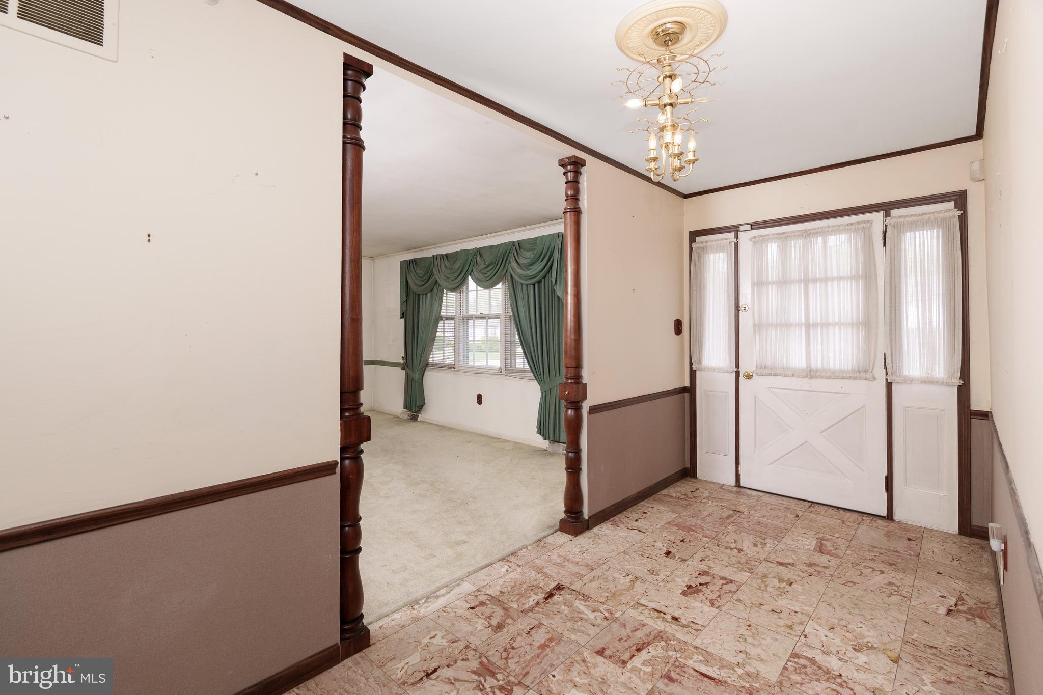 112 Park Towne Drive Elkton, MD 21921 - Photo 6 of 18 a view of a big room with a chandelier fan and windows