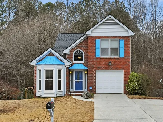 a front view of a house with garden