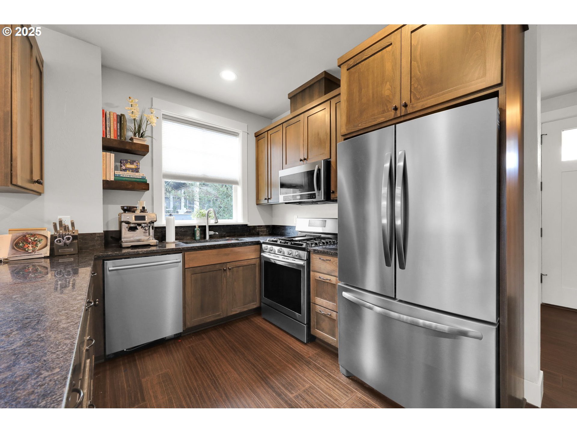 2819 Adams Street Eugene, OR 97405 - Photo 11 of 44 a kitchen with stainless steel appliances granite countertop a refrigerator a sink dishwasher a stove with wooden floor