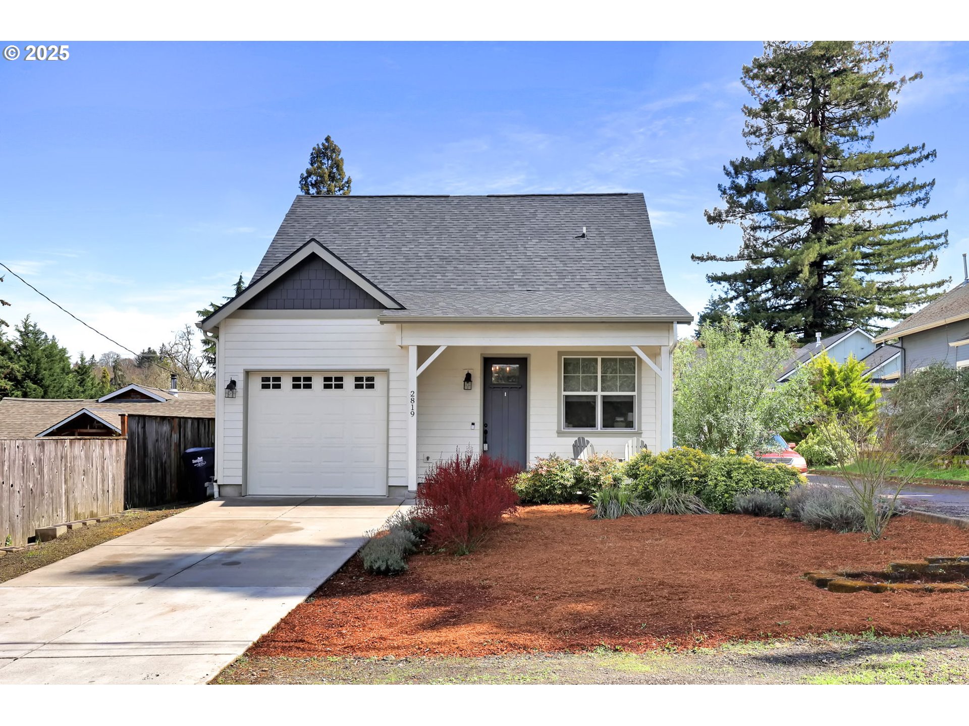 2819 Adams Street Eugene, OR 97405 - Photo 2 of 44 a front view of a house with a yard and potted plants