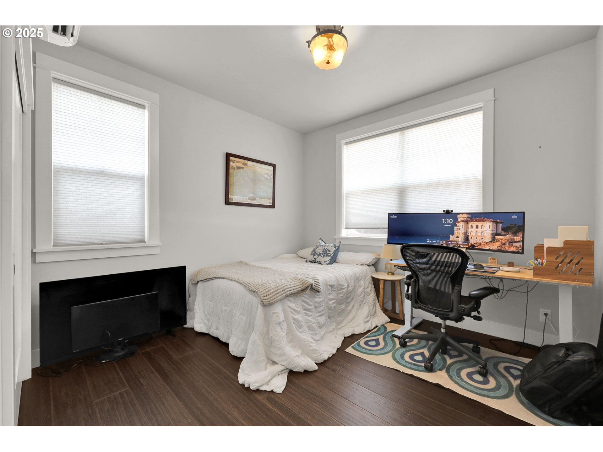 2819 Adams Street Eugene, OR 97405 - Photo 37 of 44 a living room with furniture a window and a flat screen tv