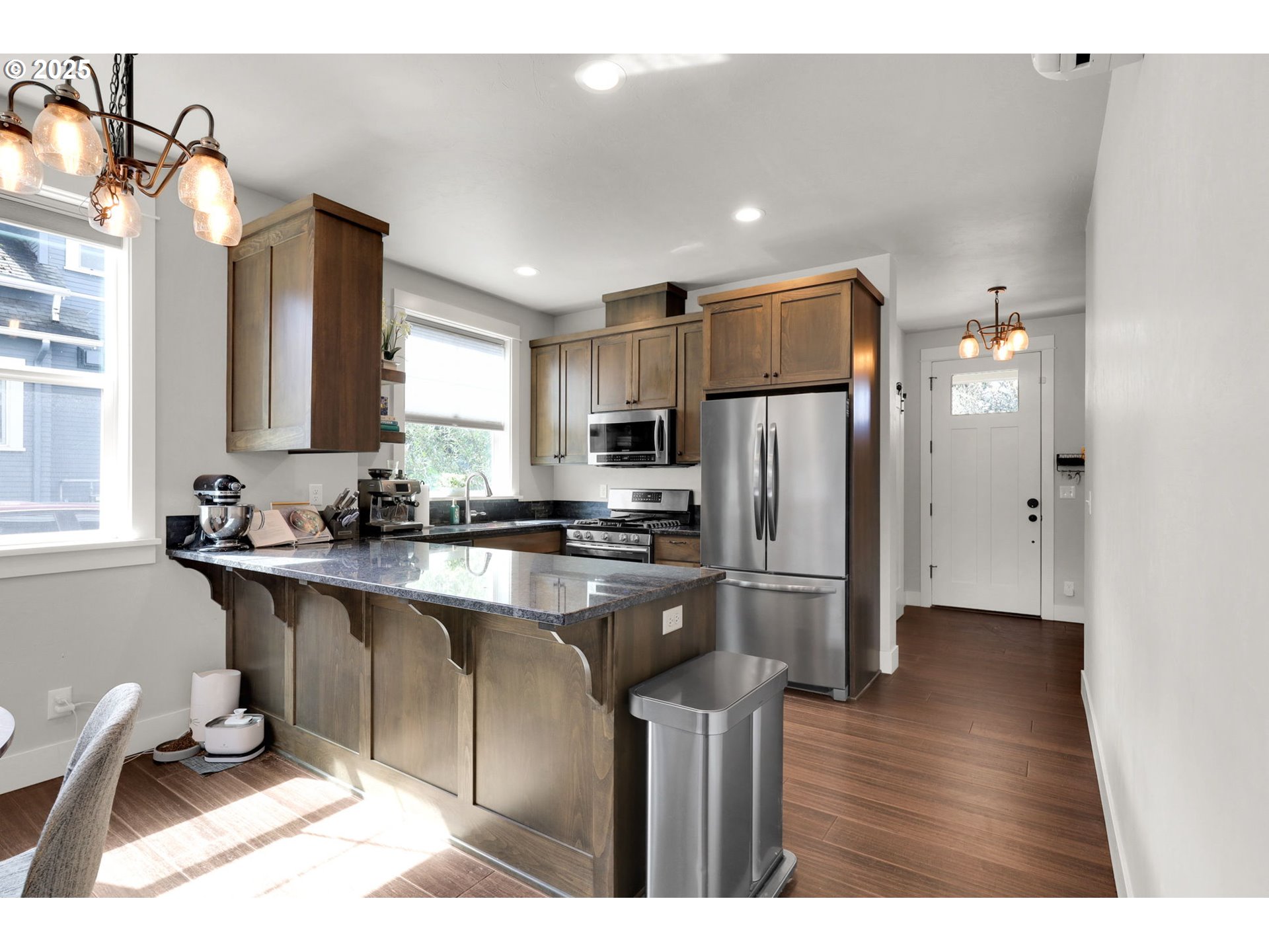 2819 Adams Street Eugene, OR 97405 - Photo 9 of 44 a kitchen with stainless steel appliances granite countertop a refrigerator a sink a stove a microwave and island