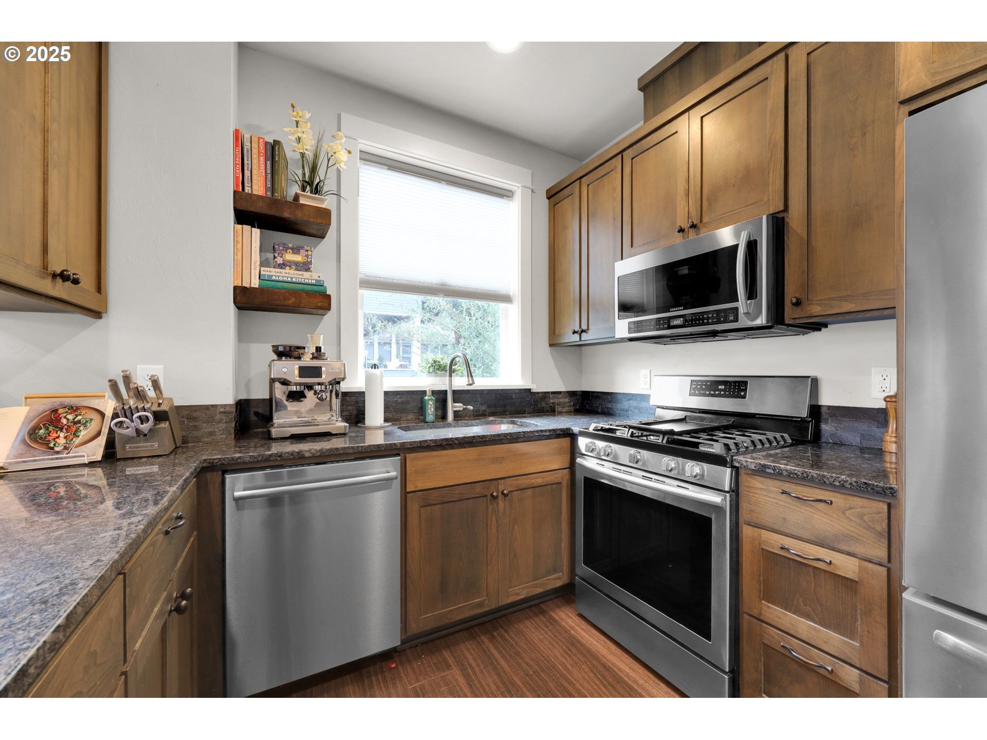 2819 Adams Street Eugene, OR 97405 - Photo 10 of 44 a kitchen with stainless steel appliances granite countertop a stove sink microwave and window