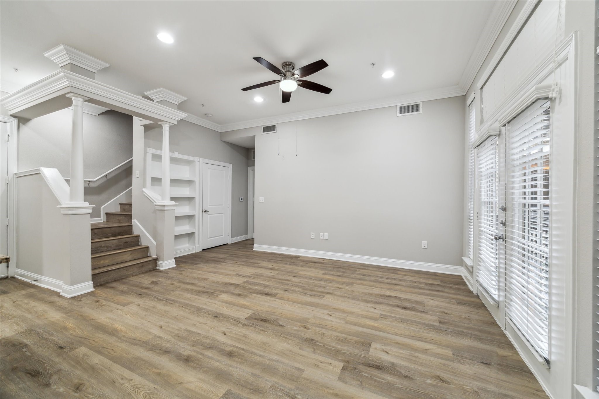 5353 Memorial Drive, Unit 3038 Houston, TX 77007 - Photo 2 of 27 an empty room with wooden floor and windows