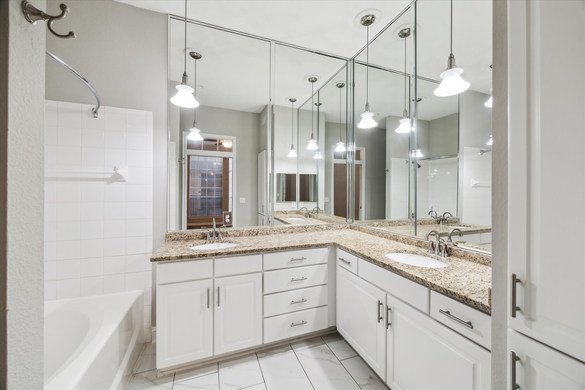 5353 Memorial Drive, Unit 3038 Houston, TX 77007 - Photo 6 of 27 a spacious bathroom with a granite countertop sink mirror and a shower