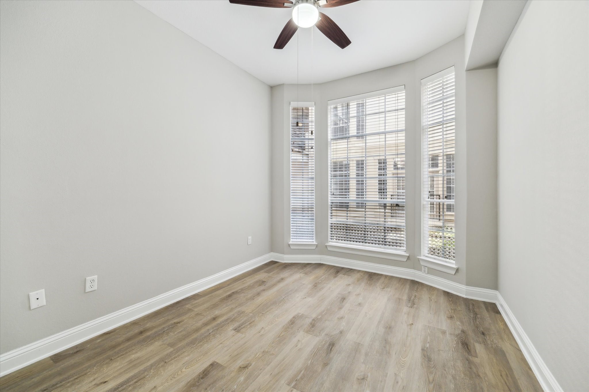 5353 Memorial Drive, Unit 3038 Houston, TX 77007 - Photo 9 of 27 an empty room with wooden floor and windows