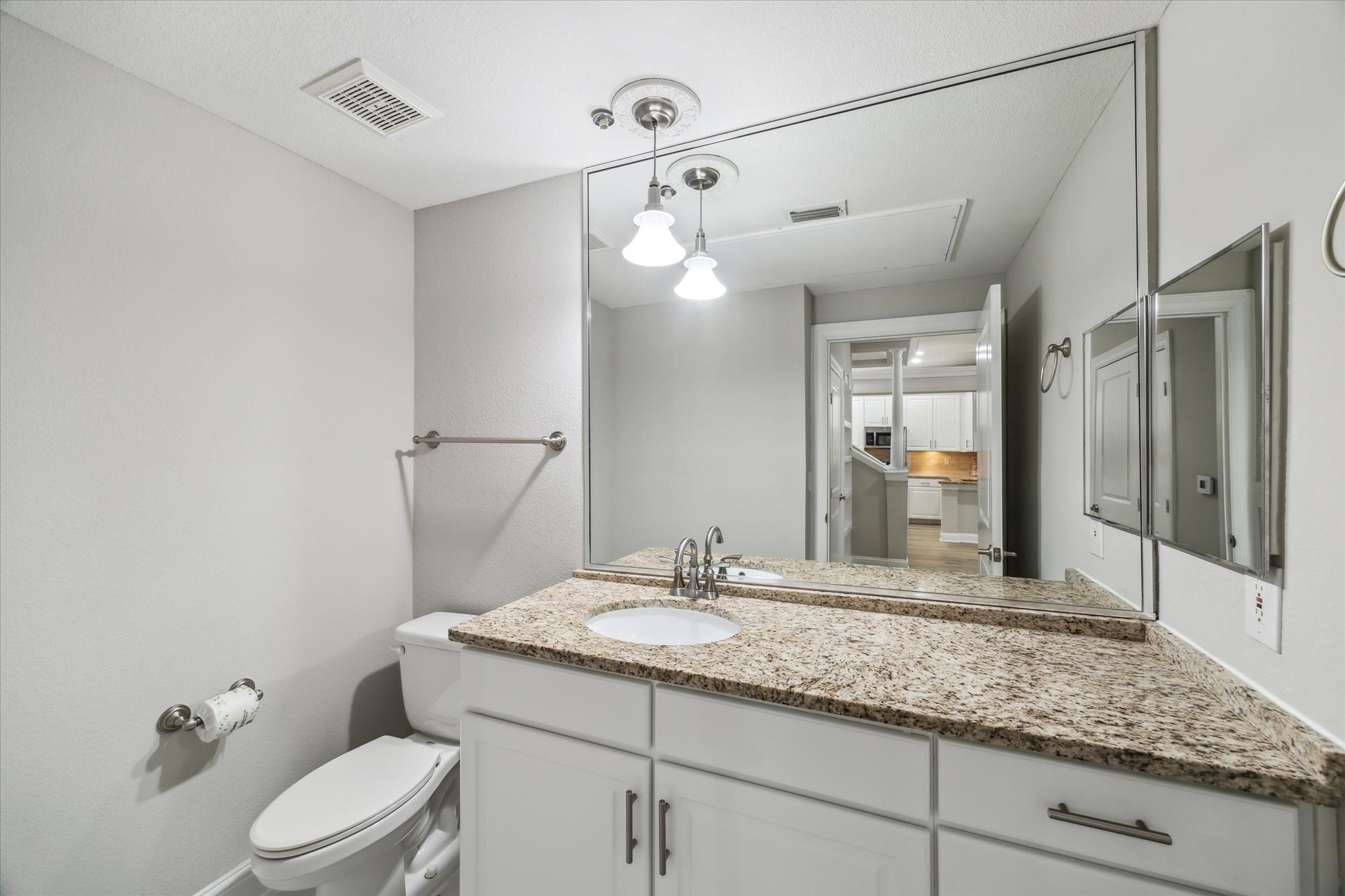 5353 Memorial Drive, Unit 3038 Houston, TX 77007 - Photo 10 of 27 a bathroom with a granite countertop sink a toilet a mirror and shower