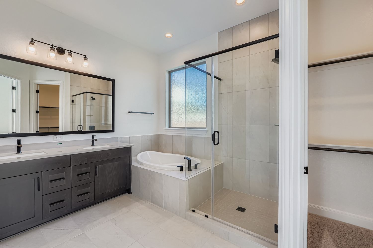 480 Prickly Poppy Loop Kyle, TX 78640 - Photo 6 of 11 a bathroom with a tub a sink and mirror