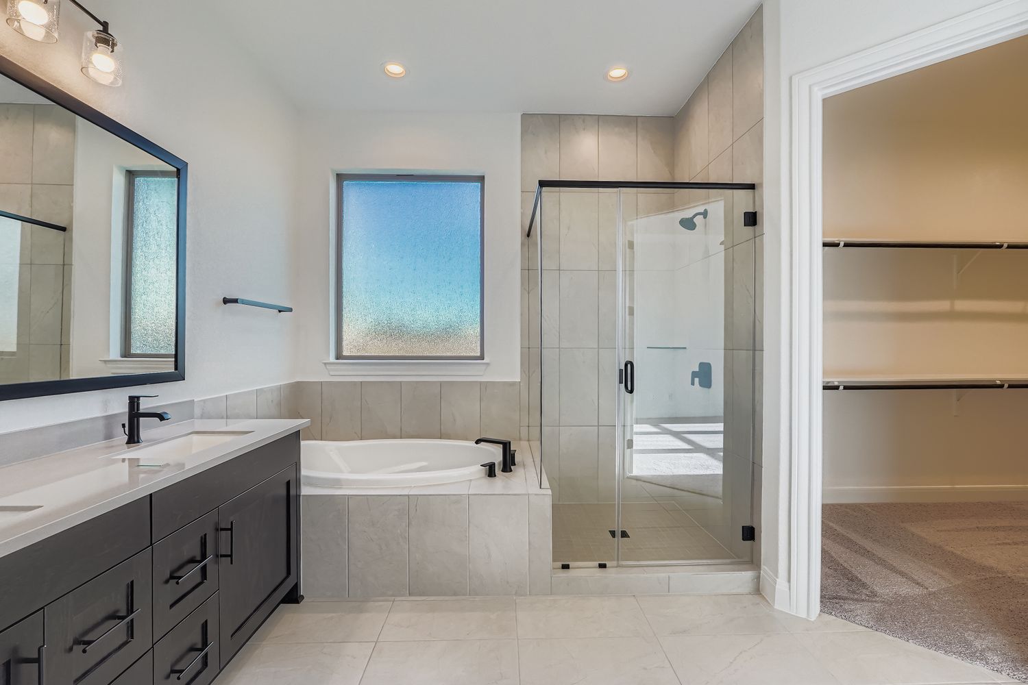 480 Prickly Poppy Loop Kyle, TX 78640 - Photo 7 of 11 a bathroom with a tub sink shower and mirror
