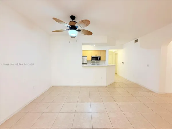 a view of a livingroom with a ceiling fan and window