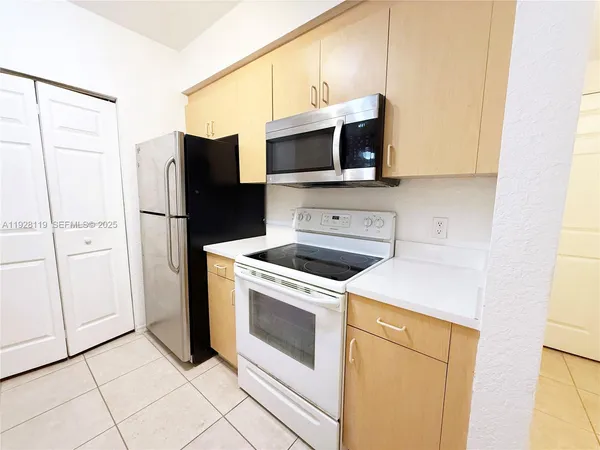 a kitchen with a sink and a refrigerator