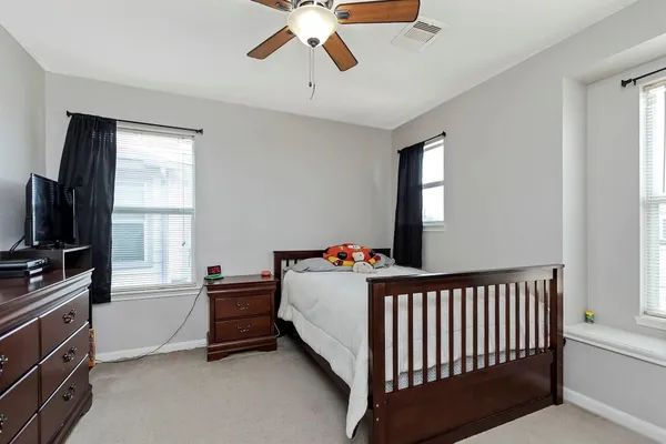 a bedroom with furniture and a window