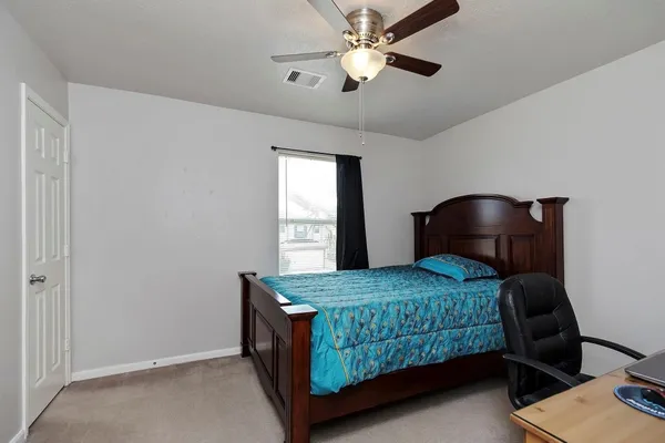 a bedroom with a bed and window
