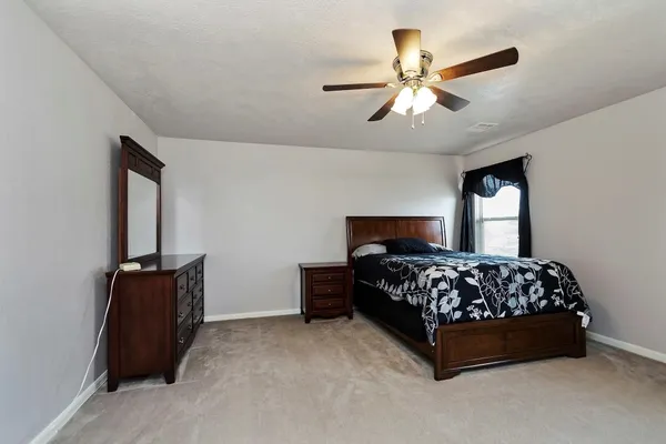 a bedroom with a bed and window