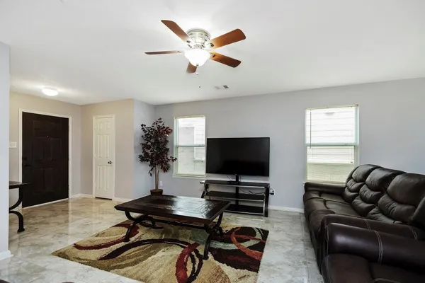 a living room with furniture and a flat screen tv