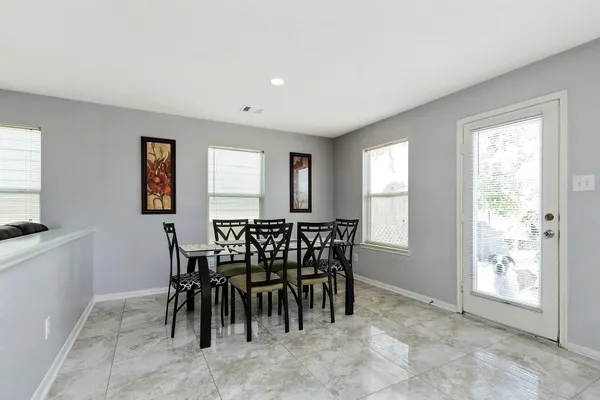 a view of a dining room with furniture and a window