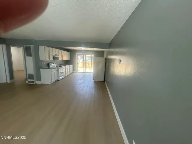 a view of hallway with wooden floor
